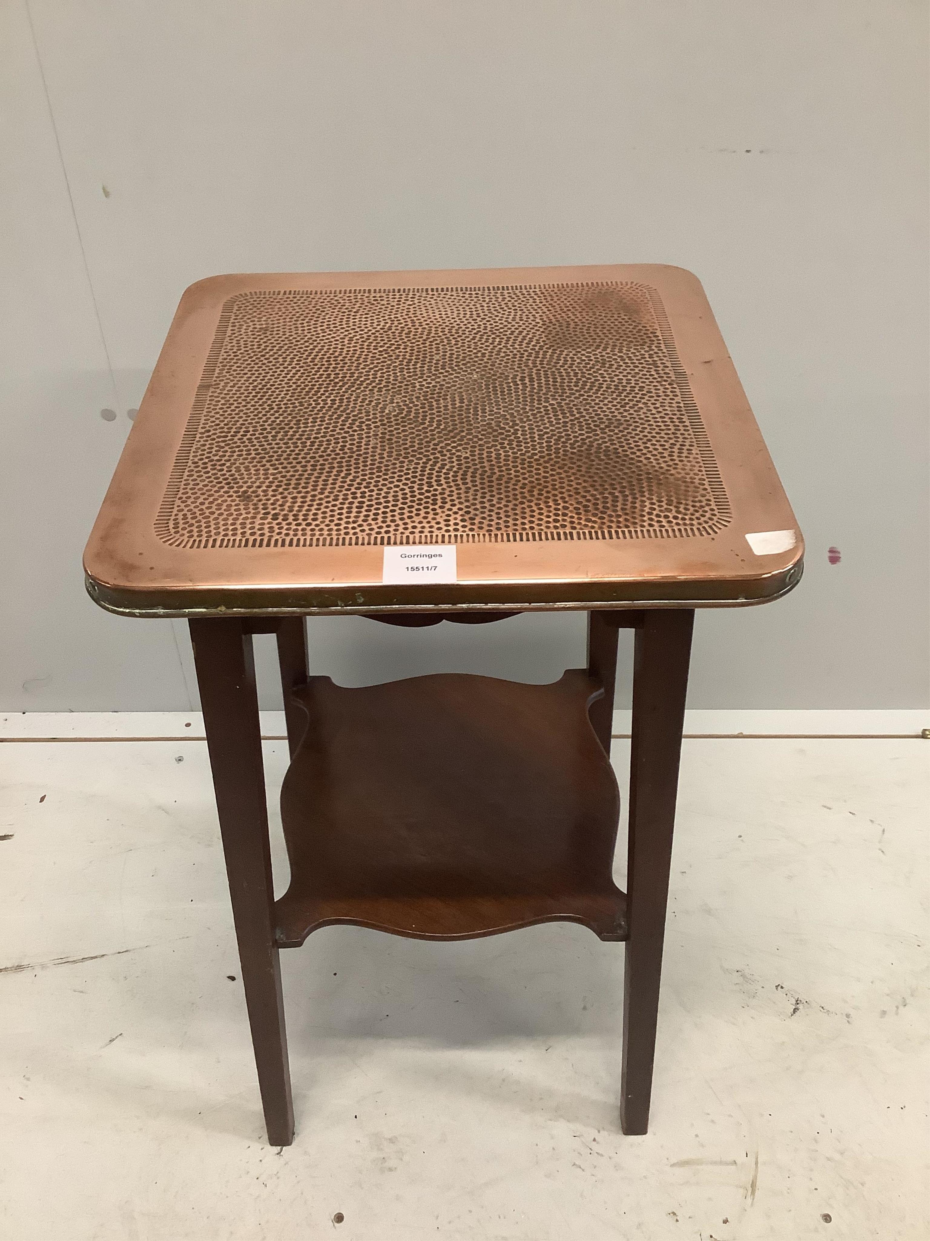 An early 20th century mahogany two tier table with hammered copper top, width 40cm, depth 40cm, height 69cm. Condition - fair to good